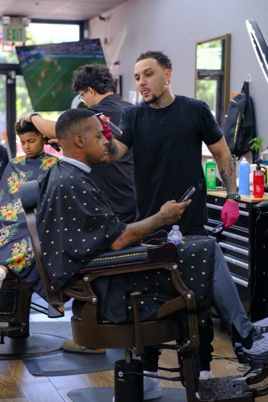 Barber finishing a taper fade at Tay's Barbershop Sacramento